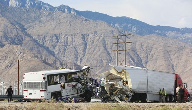 Investigators confer at the scene of the bus crash on the westbound Interstate 10 freeway near Palm Springs, California.