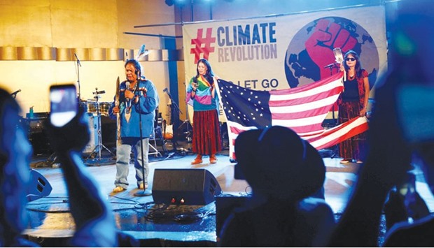 Joann Mae Spotted Bear says a prayer on stage during a climate change rally in solidarity with protests of the pipeline in North Dakota at MacArthur Park in Los Angeles, California.