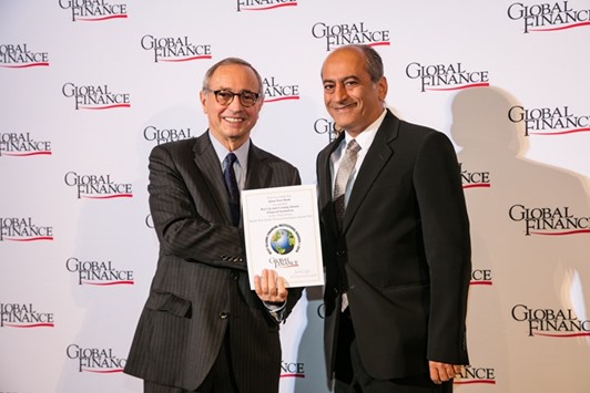 Al-Salhi (right) receiving the award from Global Finance.