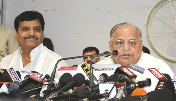 Samajwadi Party chief Mulayam Singh Yadav (right) speaks at a press conference as party leader Shivpal Yadav looks on in Lucknow yesterday.