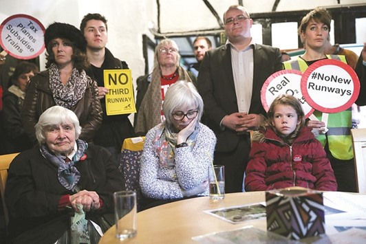 Residents of Harmondsworth village watch television in the Five Bells pub as Transport Secretary Chris Grayling announces the governmentu2019s decision to build a new runway at Heathrow Airport, in Harmondsworth, yesterday.