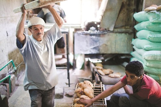 Workers collect freshly baked bread inside a bakery in Cairo. Egypt bought 420,000 metric tonnes of Russian and Romanian wheat in its latest tender on Tuesday, the biggest purchase in two years.