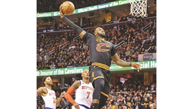 LeBron James (No 23) of the Cleveland Cavaliers finishes off a fast break with a dunk in the third quarter as Carmelo Anthony (No 7) of the New York Knicks looks on at Quicken Loans Arena in Cleveland. (AFP)