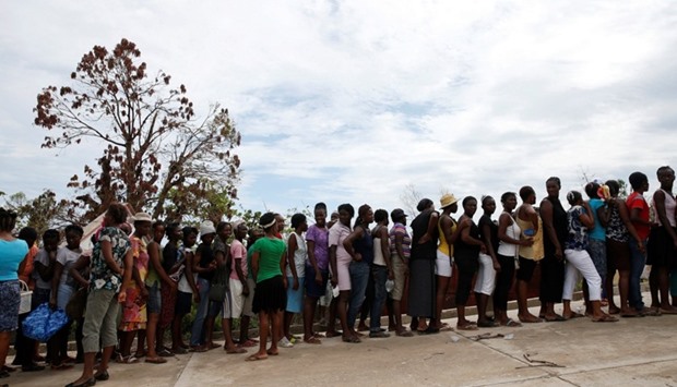People make a line as they wait for food to be handed out after Hurricane Matthew hit Jeremie, Haiti.  October 19, 2016 file picture