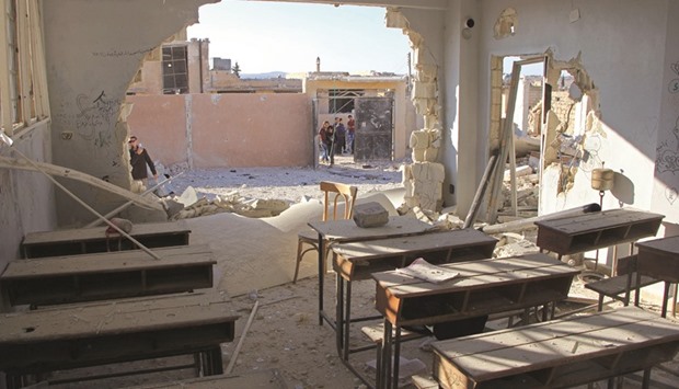 A general view shows a damaged classroom at a school after it was hit in an air strike in the village of Hass, in the south of Syriau2019s rebel-held Idlib province yesterday.