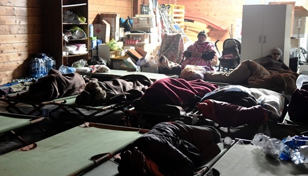 People gather to sleep in a secured area after earthquakes in the village of Visso, central Italy.