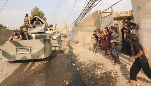 Children welcome Kurdish Peshmerga fighters after peshmerga recaptured Fadiliya village in Nawaran, north of Mosul, from Islamic State militants.