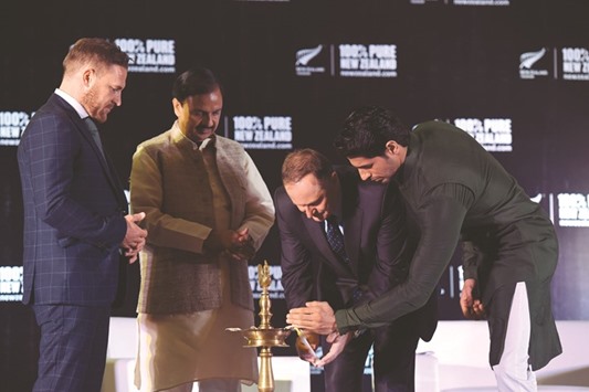 Indiau2019s Tourism and Cultural Minister Mahesh Sharma watches as Bollywood actor and Tourism New Zealand Brand Ambassador Sidharth Malhotra (right) and New Zealand Prime Minister John Key light a traditional lamp during an event in New Delhi yesterday.