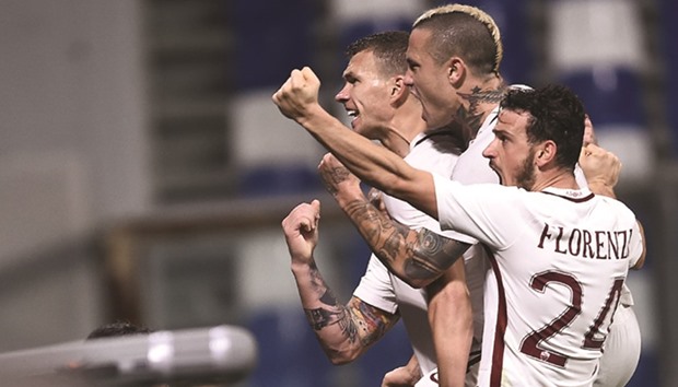 Romau2019s Edin Dzeko (left) celebrates with teammates after a scoring a goal during the Serie A match against Sassuolo. (AFP)