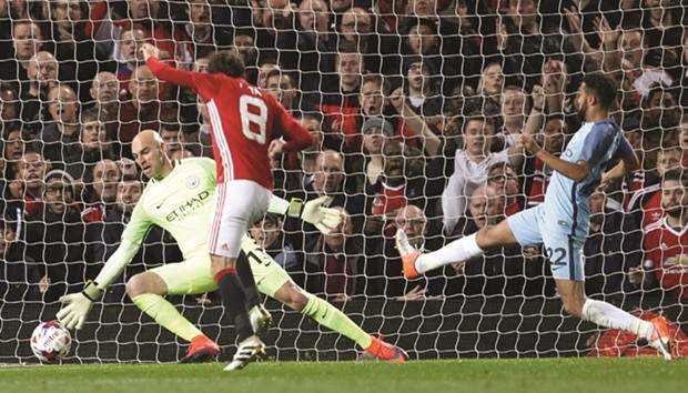 Manchester Unitedu2019s Juan Mata scores a goal during the English Football League Cup match against Manchester City at Old Trafford on Wednesday night. (Reuters)
