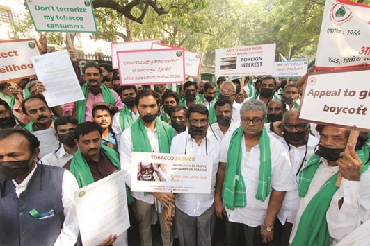 Tobacco farmers under the banner of the Federation of All India Farmers Association stage a demonstration against the upcoming WHO conference, in New Delhi yesterday.