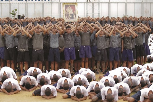 Male inmates pay their respects to the late Thai King Bhumibol Adulyadej at the Central Correctional Institution for Young Offenders in Pathum Thani province, on the outskirts of Bangkok.