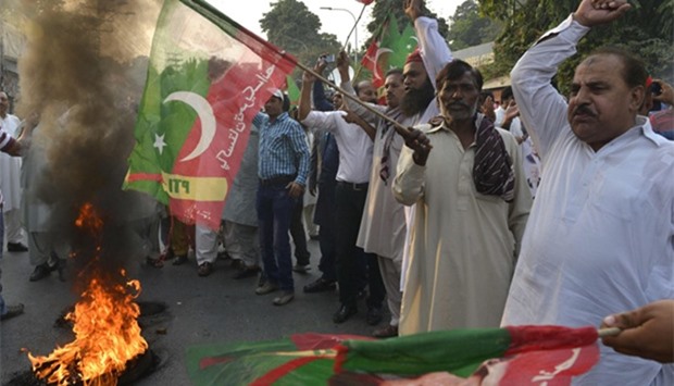 Activists of Pakistan Tehreek Insaaf party shout slogans during protest