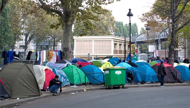 Tents are seen at a makeshift migrant camp on a street near the metro stations of Jaures and Stalingrad in Paris
