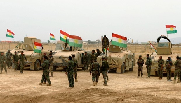 Kurdish military vehicles are seen during a battle with Islamic State militants