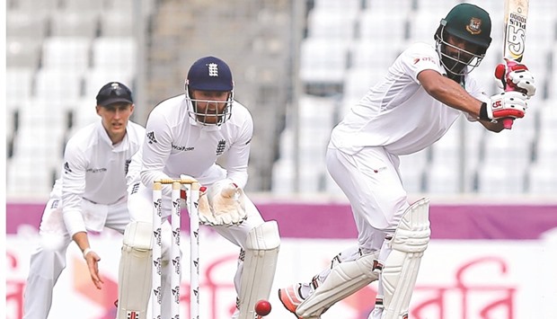 Bangladeshu2019s Tamim Iqbal (right) plays a shot as England wicketkeeper Jonathan Bairstow (centre) and Joe Root look on on Day One of the second Test in Dhaka, Bangladesh, yesterday. (Reuters)