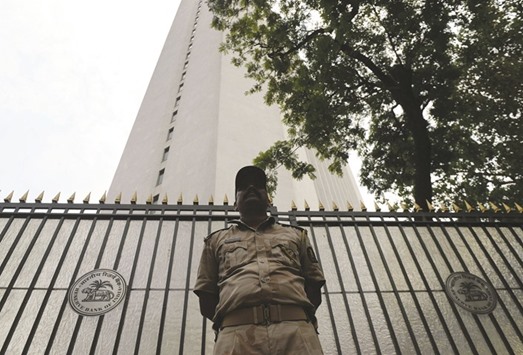 An Indian security guard stands outside the Reserve Bank of India headquarters in Mumbai. The RBIu2019s involvement in Indiau2019s foreign-exchange market underwent a sea change after the rupee fell to a record low of 68.8450 per dollar in August 2013 and Morgan Stanley named the currency as one of the u2018Fragile Fiveu2019 due to its vulnerability to capital flight.