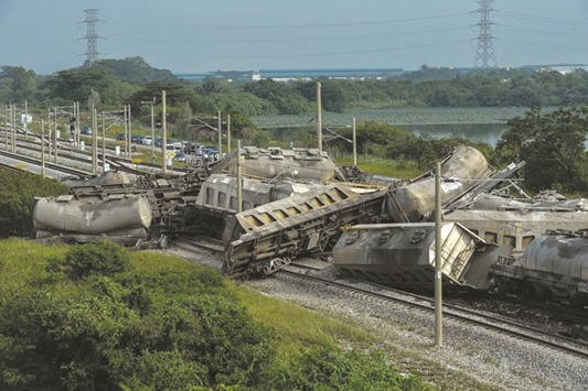 The cargo train after it derailed along a heavily travelled north-south rail corridor in the northern Malaysian state of Perak.