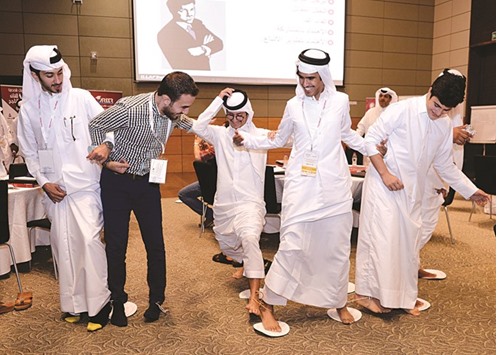 Some of the participants engage in a team building activity during a workshop.