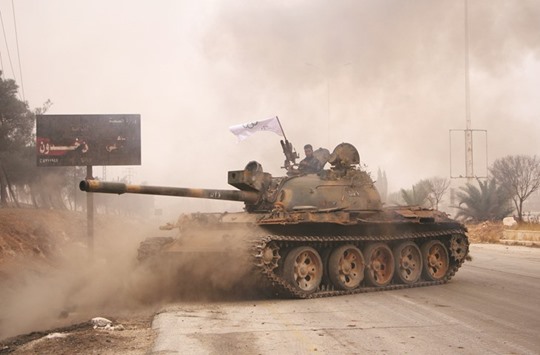 Rebel fighters from the Jaish al-Fatah (or Army of Conquest) brigades manoeuvre a T-55 tank as they take part in a major assault on Syrian government forces West of Aleppo city yesterday.