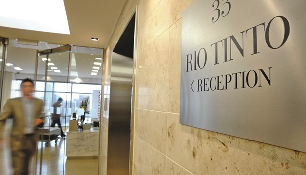 A man walks through the entrance from the reception area of Rio Tintou2019s head office in Melbourne. Rio turned its back on Simandou, one of the worldu2019s largest untapped iron ore deposits, by signing a non-binding agreement with partner Aluminum Corp of China to hand over its stake.