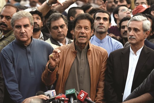 Imran Khan  talks to media outside his house in Islamabad.