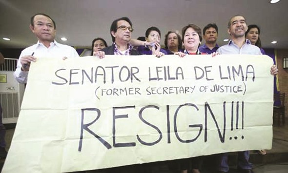 Members of the Volunteers Against Crime and Corruption call on Senator Leila de Lima to resign following a news conference in Manila.