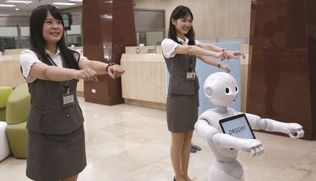 SoftBanku2019s robot u2018Pepperu2019 performs with employees at First Bank branch in Taipei. Promoted as the first robot to be endowed with emotions, the company marketed the robot aggressively after it was unveiled in 2014, promising the gadget was sophisticated enough for tasks usually handled by shop clerks, receptionists and translators.
