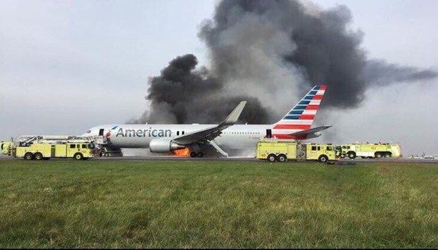 Footage from Chicago's ABC News affiliate station, WLS-TV, showed the idled plane on the ground with flames and large clouds of black smoke billowing from its right side