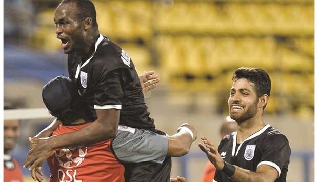 Al Saddu2019s  Abdelkarim Hassan is congratulated by teammates after he scored against Al Gharafa.