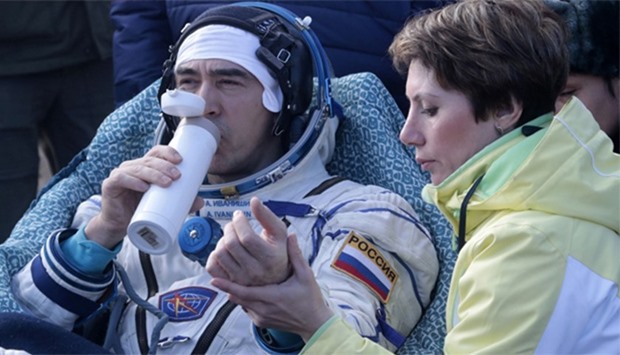 Russian cosmonaut Anatoly Ivanishin rests in chairs outside the Soyuz MS space capsule