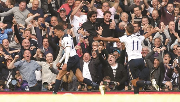 Tottenhamu2019s Dele Alli (left) celebrates with Erik Lamela after scoring his teamu2019s second goal in their 2-0 win over Manchester City at White Hart Lane in North London yesterday. (Reuters)