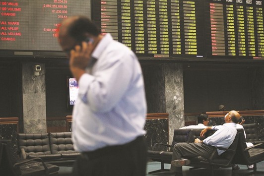 Traders monitor stocks in a trading hall at the Karachi Stock Exchange. Pakistanu2019s stocks are headed for the worst weekly drop since June as political tensions add to concern that the rally that made it Asiau2019s best-performing market was overdone.