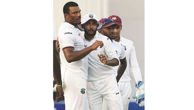 West Indiesu2019 bowler Shannon Gabriel (L) celebrates with teammate Devendra Bishoo after the dismissal of Pakistani batsman Sarfraz Ahmed unseen on the first day of the third and final Test at the Sharjah Cricket Stadium in Sharjah yesterday. (AFP)