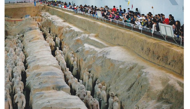 This photo taken on October 21 shows visitors taking photos of sculptures of the terracotta army at the Terracotta Warrior Museum in Xian, in north Chinau2019s Shaanxi province.