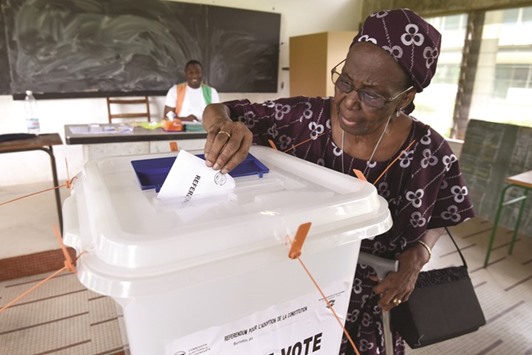 A woman casts her vote at a polling station in Abidjan yesterday.