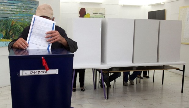 A man casts his ballot yesterday at a voting station in the western Bosnian town of Banja Luka.