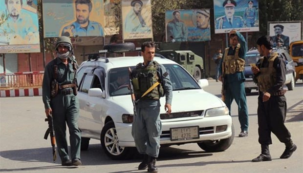 Afghan policemen keep watch in Kunduz city on Monday.