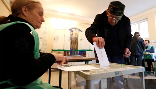 A man casts his ballot during the second round of parliamentary election in Tbilisi