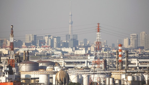 Chimneys of an industrial complex and Tokyou2019s skyline are seen from an observatory deck at a port in Kawasaki. In the July-September quarter, Japanu2019s industrial output rose 1.1%, faster than a 0.2% gain in the previous quarter, but economists say growth could moderate slightly in October-December.
