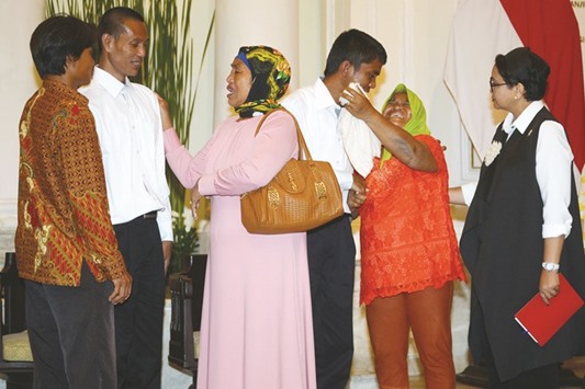 Indonesian Minister of Foreign Affairs Retno Marsudi (right) looks on as Adi Manurung (third right), and Supardi (second left), two of four freed sailors who were held hostage for nearly five years by Somali pirates, are reunited with relatives at the Foreign Ministry office in Jakarta yesterday.