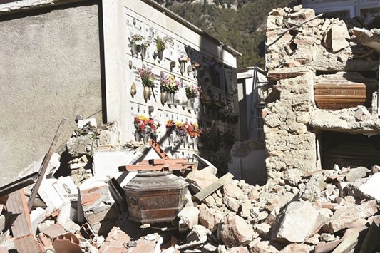 Exposed coffins are seen yesterday in the rubble of the collapsed cemetery of Campi near Norcia, a day after a 6.6 magnitude earthquake hit central Italy.