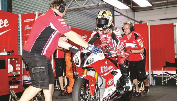 The pit crew assist Milwaukee BMW rider Karel Abraham as he gets ready to go out on track during the just-concluded World Superbike Championship at Losail circuit.