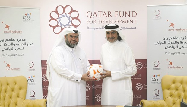 Qatar Charity CEO Yusuf bin Ahmed al-Kuwari (left) and ICSS president Mohamed Hanzab at the Qatar Development Fund (QDF) headquarters for the agreement-signing ceremony.