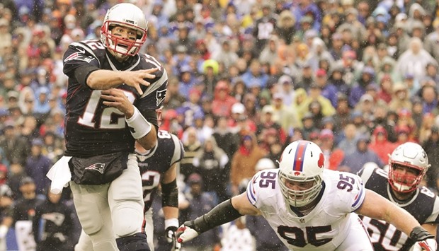 Tom Brady (No 12) of the New England Patriots throws a touchdown pass to Danny Amendola #80 of the New England Patriots against the Buffalo Bills during the first half at New Era Field in New York. (AFP)