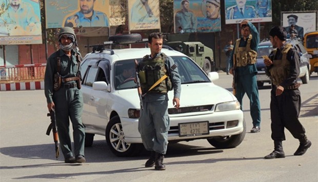 Afghan policemen keep watch in the downtown of Kunduz city