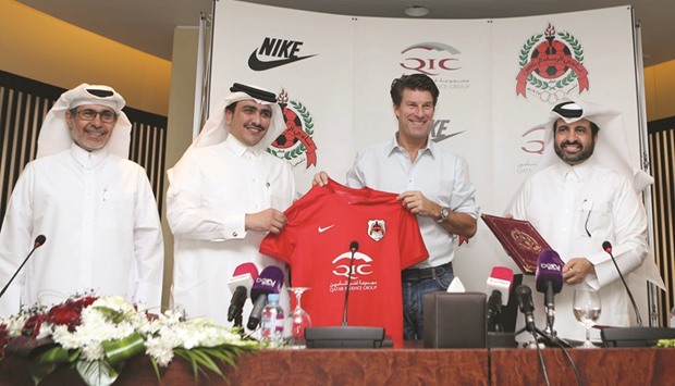 Newly-appointed Al Rayyan head coach Michael Laudrup (2ndR) poses with the clubu2019s president Sheikh Saud bin Khaled bin al-Thani (2ndL), the team manager Ali Salem Afifa (L), and the secretary general Abdullah al-Mutawa during a press conference yesterday.  PICTURE: Karim Jaafar / AFP