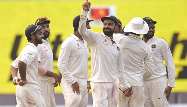 Indian captain Virat Kohli (centre) celebrates the wicket of New Zealandu2019s BJ Watling with teammates on Day Four of the second Test in Kolkata, India, yesterday. (AFP)