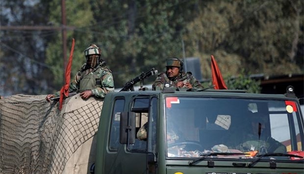 Indian soldiers keep guard along a highway on the outskirts of Srinagar on Monday.