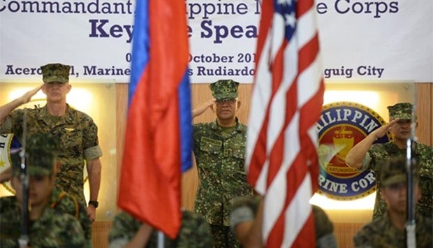 US marines Brigadier General John Jansen (left), Philippines marines Major General Andre Costales (centre) and Brigadier General Maximo Ballesteros salute during the opening ceremony of the Amphibious Landing Exercise (PHIBLEX) at the marines headquarters in Manila on Tuesday